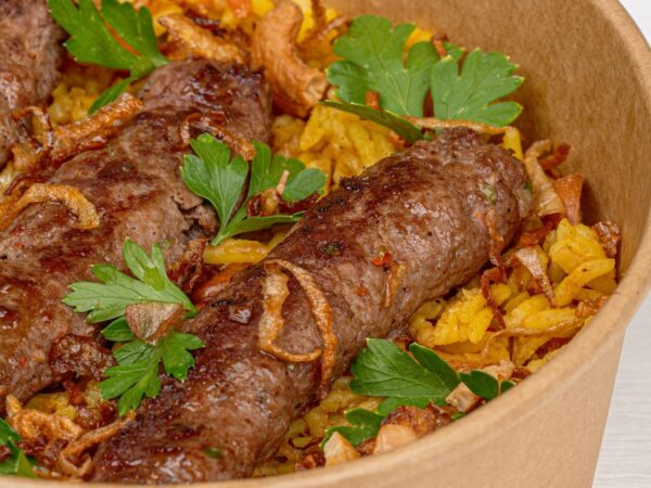 Savor the flavors of Middle Eastern kebabs served on a bed of seasoned rice. Perfect for food lovers.