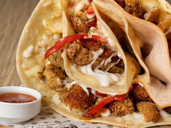 Scrumptious chicken wrap with creamy sauce and peppers, perfect for food enthusiasts.